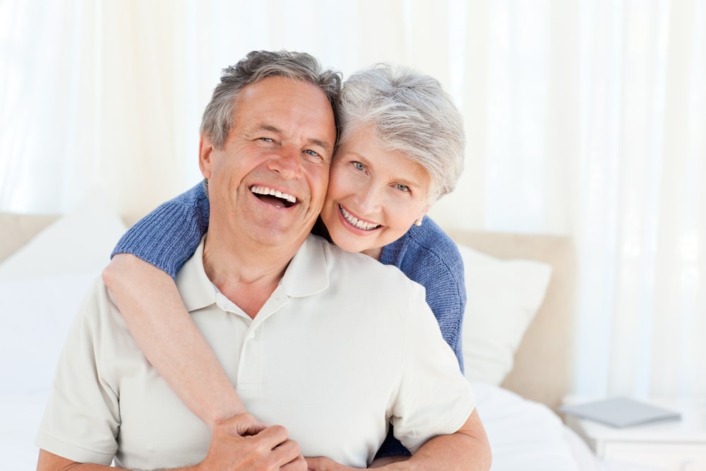 Senior Couple showing new smile after teeth gap closing treament